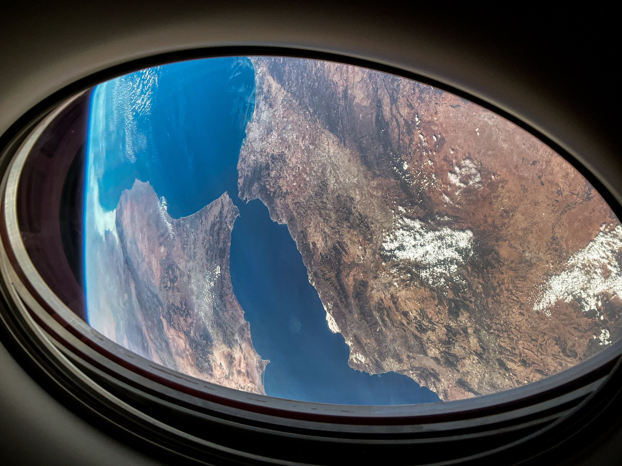 This view of Earth was captured from a window on the SpaceX Dragon Endurance spacecraft as it approached the International Space Station. Pictured below is the Strait of Gibraltar that connects the Atlantic Ocean to the Mediterranean Sea, which separates the continents of Europe and Africa.