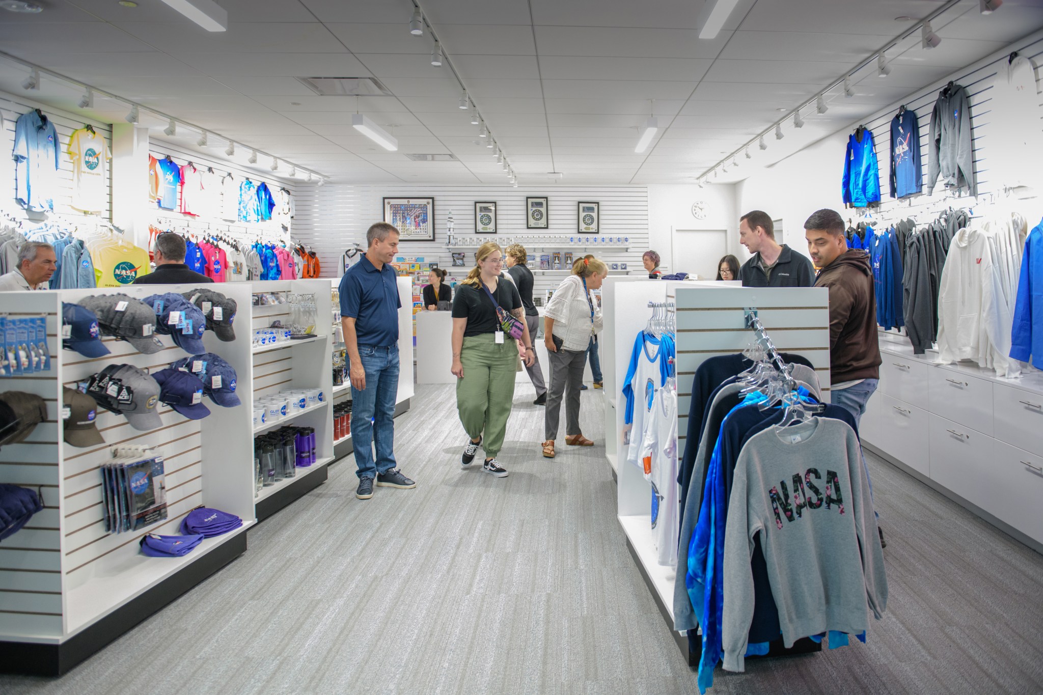 Shoppers browse in a store filled with NASA merchandise.