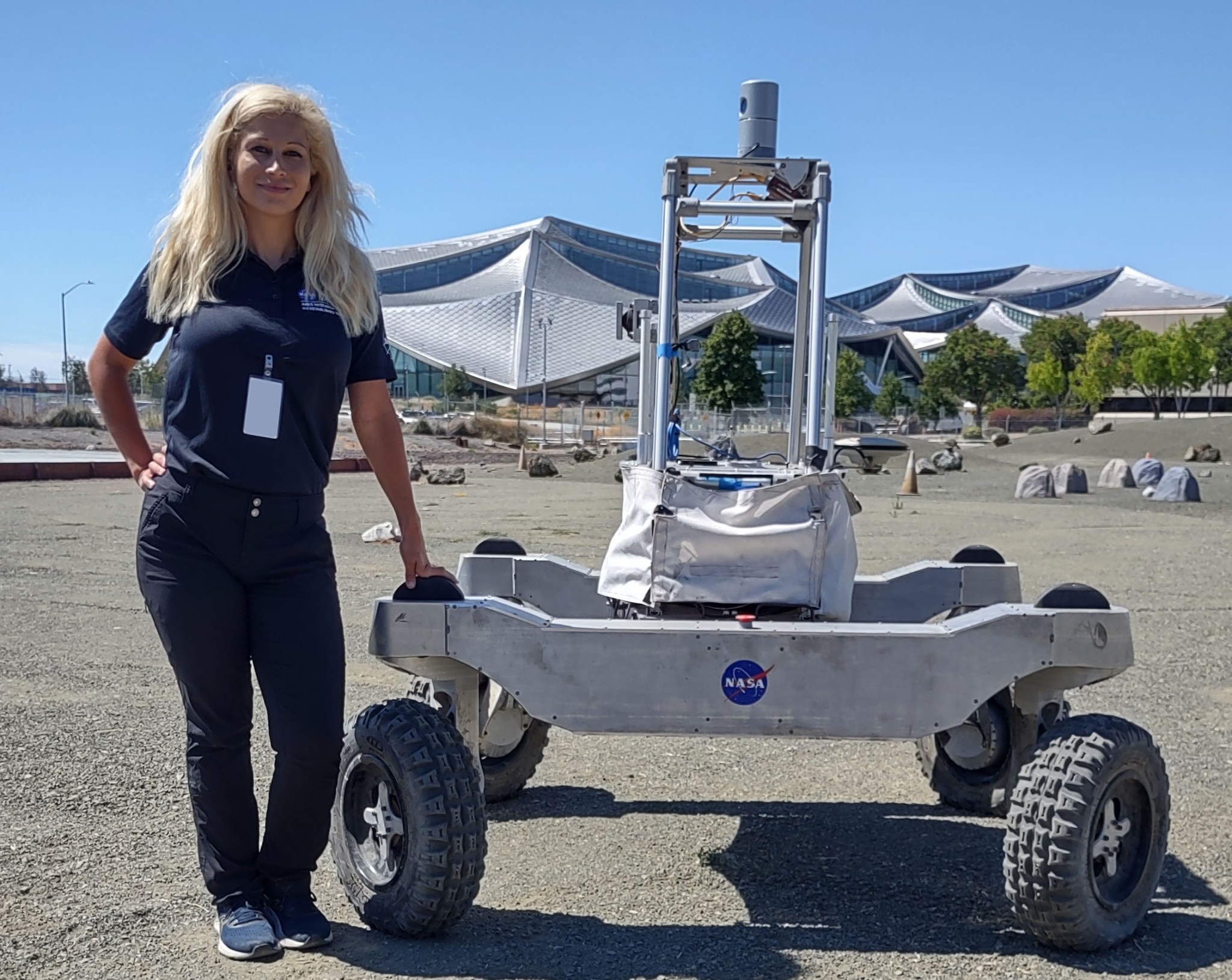 Kaitlin standing next to robot.