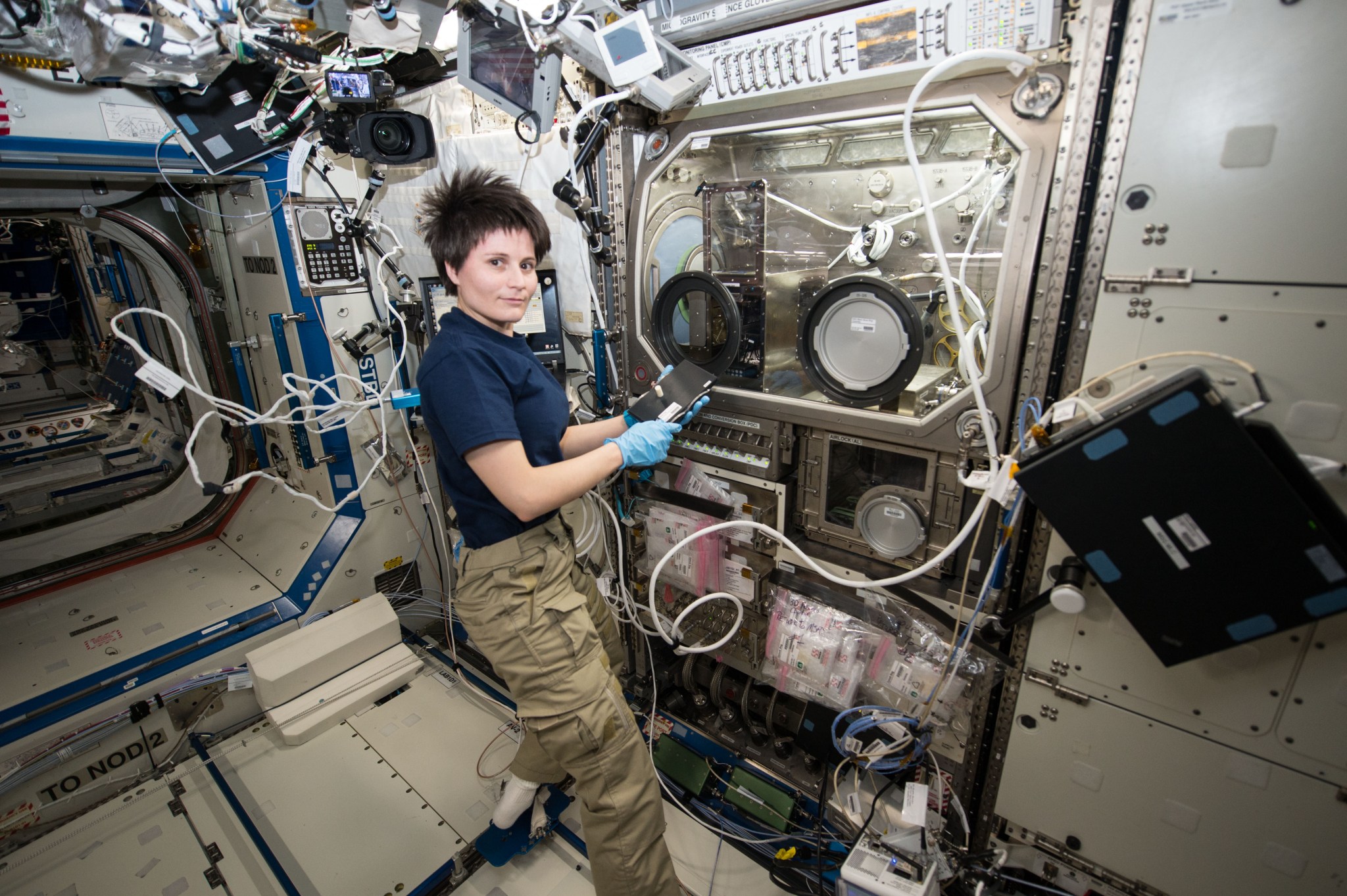European Space Agency astronaut Samantha Cristoforetti works with the Microgravity Science Glovebox aboard the International Space Station in 2014.