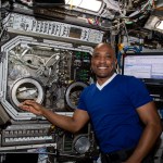 NASA astronaut Victor Glover works with a payload inside the Microgravity Science Glovebox aboard the International Space Station in 2021.
