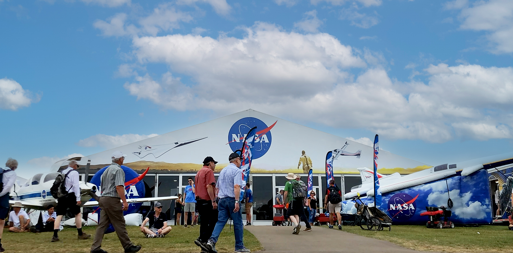 Visitors walking in front of NASA’s pavilion at Experimental Aircraft Association’s AirVenture in Oshkosh, Wisconsin.