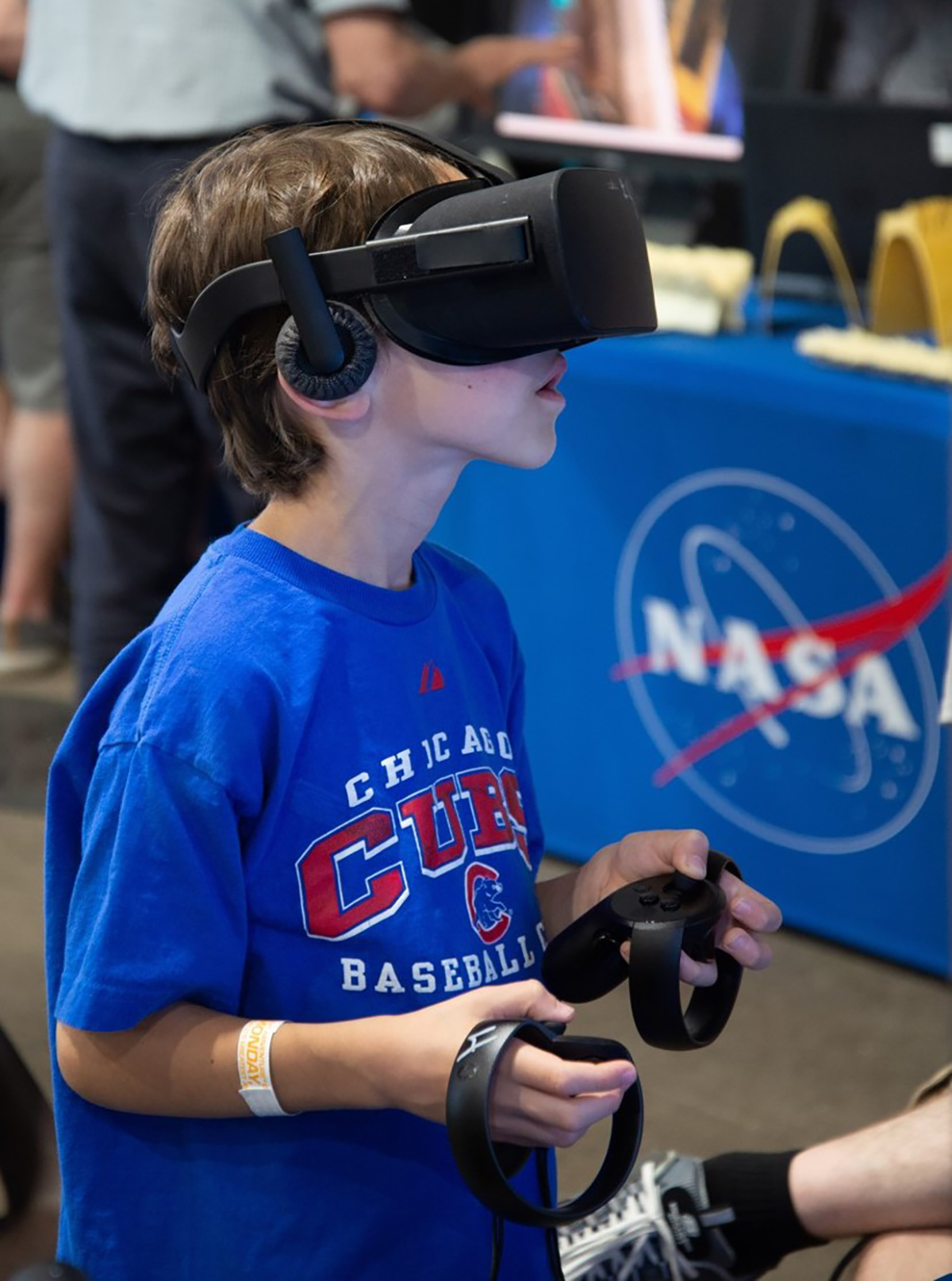 A young boy wearing virtual reality goggles.
