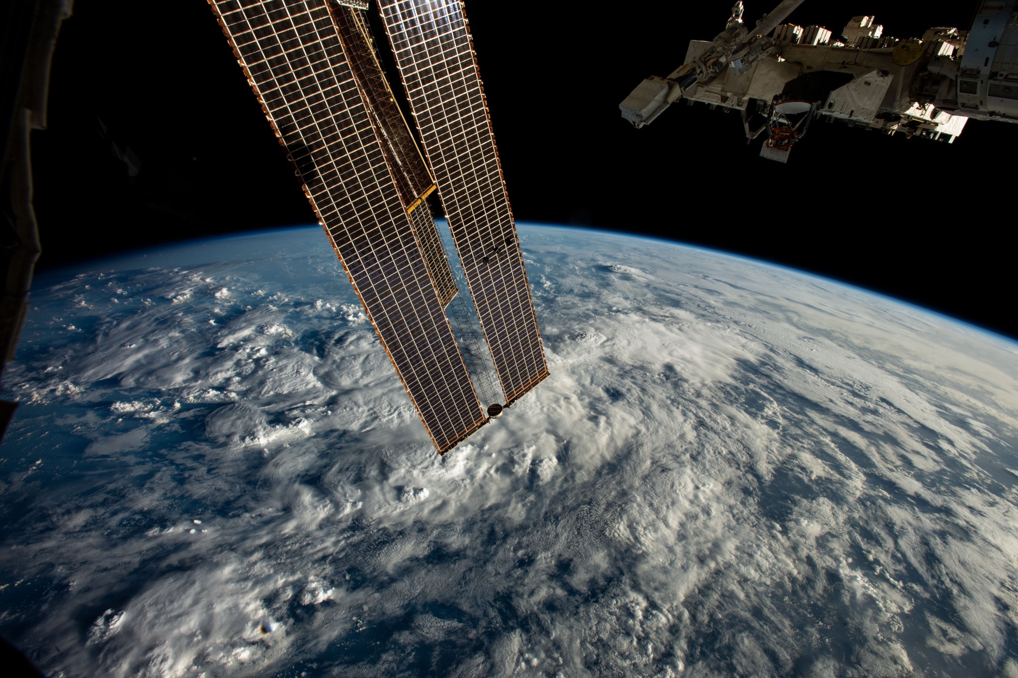 image of Earth, small satellite deployer and station solar panels