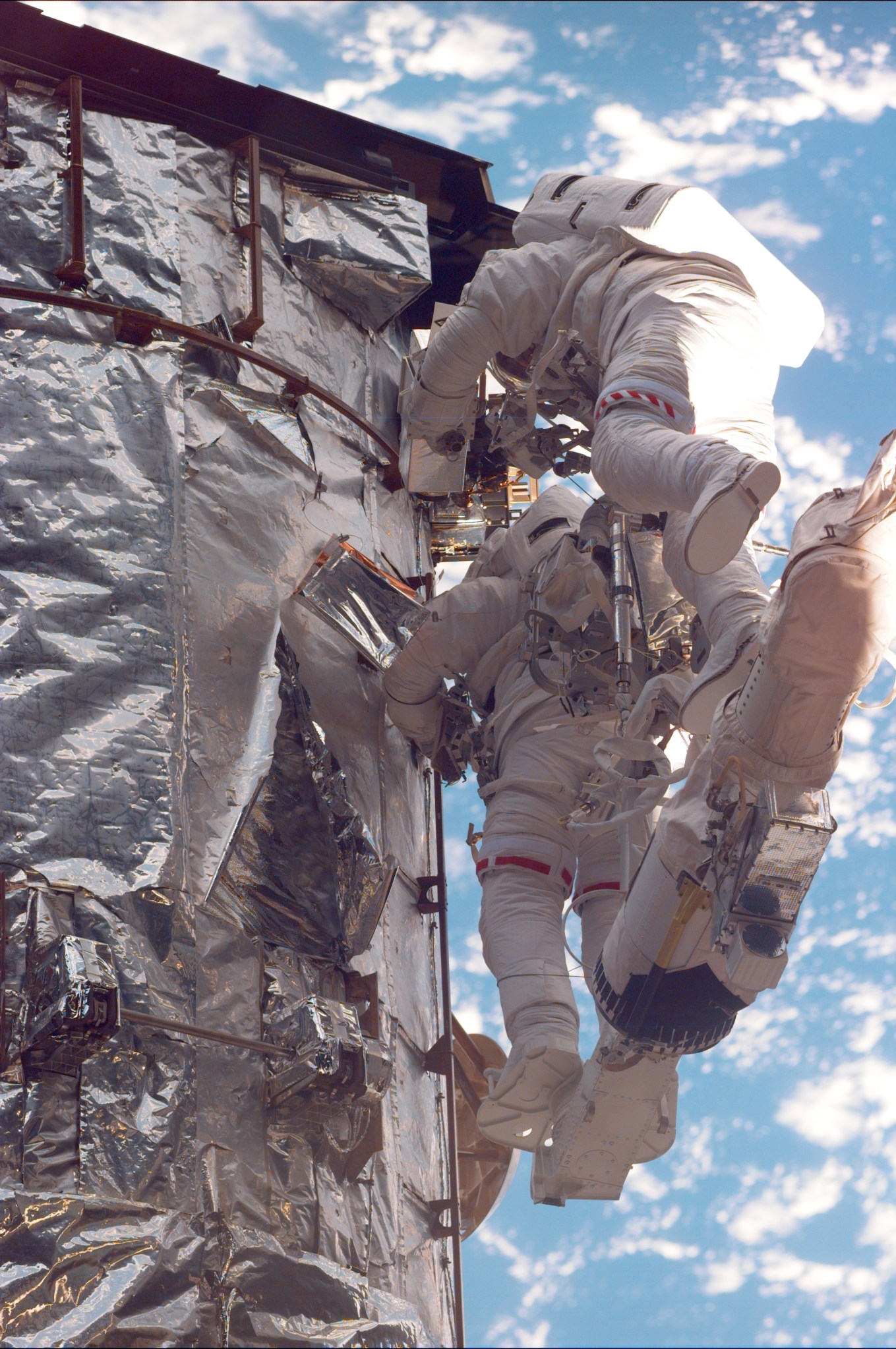 image of astronauts working on a telescope