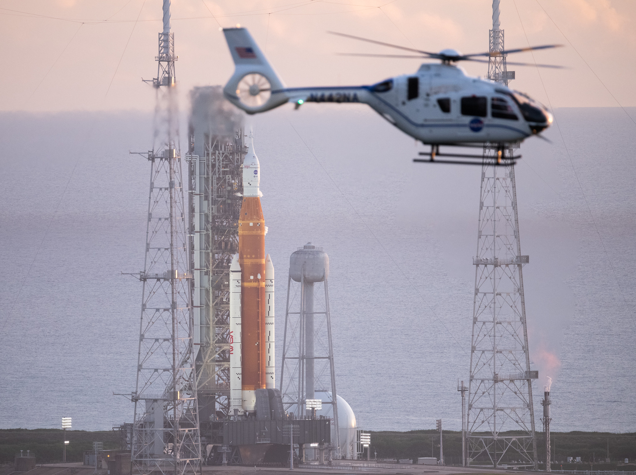 A NASA helicopter flies past the agency’s Space Launch System (SLS) rocket with the Orion spacecraft aboard atop the mobile launcher at Launch Pad 39B at NASA’s Kennedy Space Center in Florida, Monday, Aug. 29, 2022. 