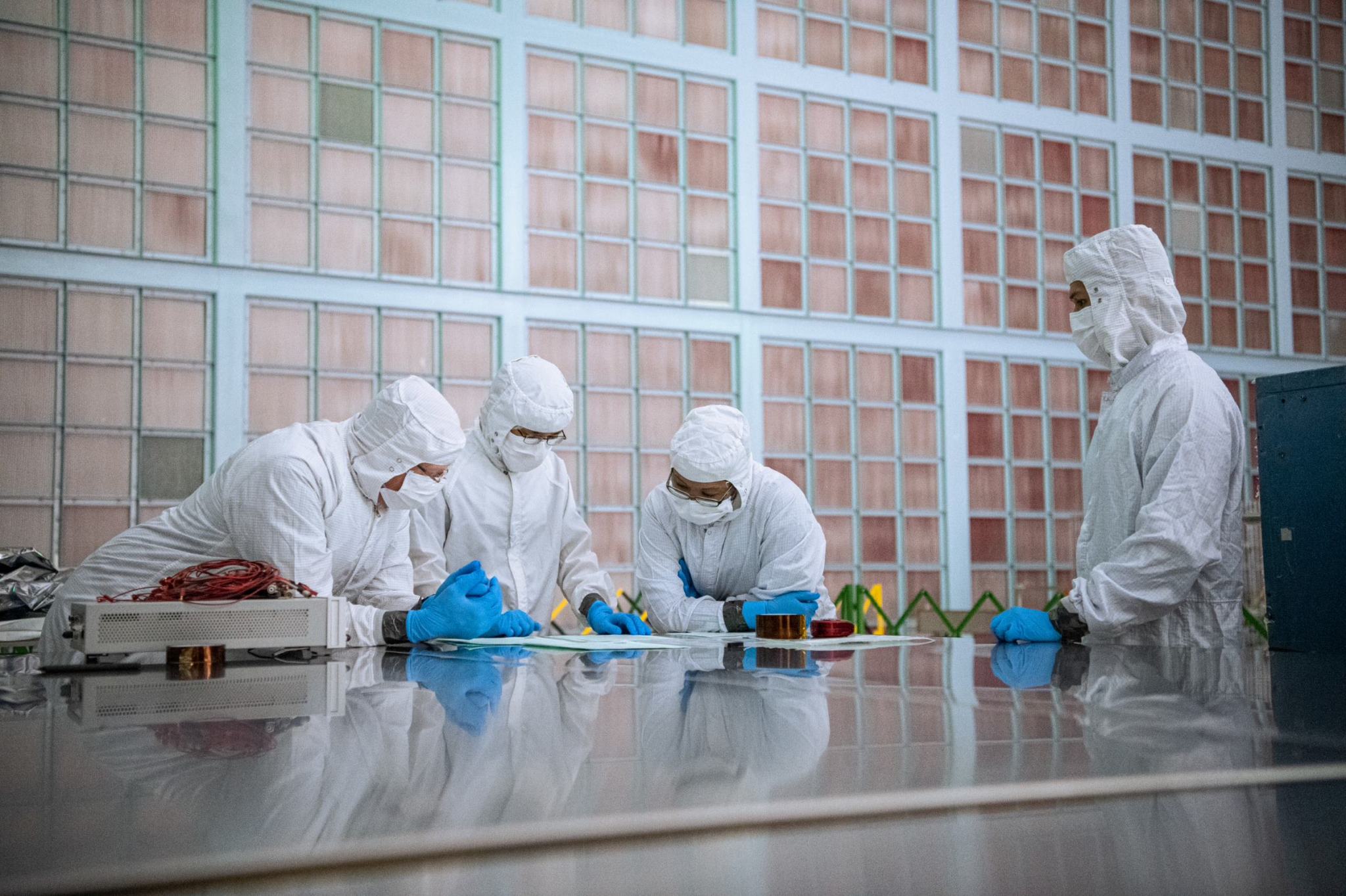 Mark Walter, David Kim, Melyane Ortiz-acosta, and Ariel Obaldo discuss plans for testing the PACE flight Solar Array Panels. n