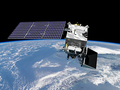 Illustration of the PACE satellite orbiting over Earth. The spacecraft has a silver body with a black extension out one side and a purple solar panel out the other.
