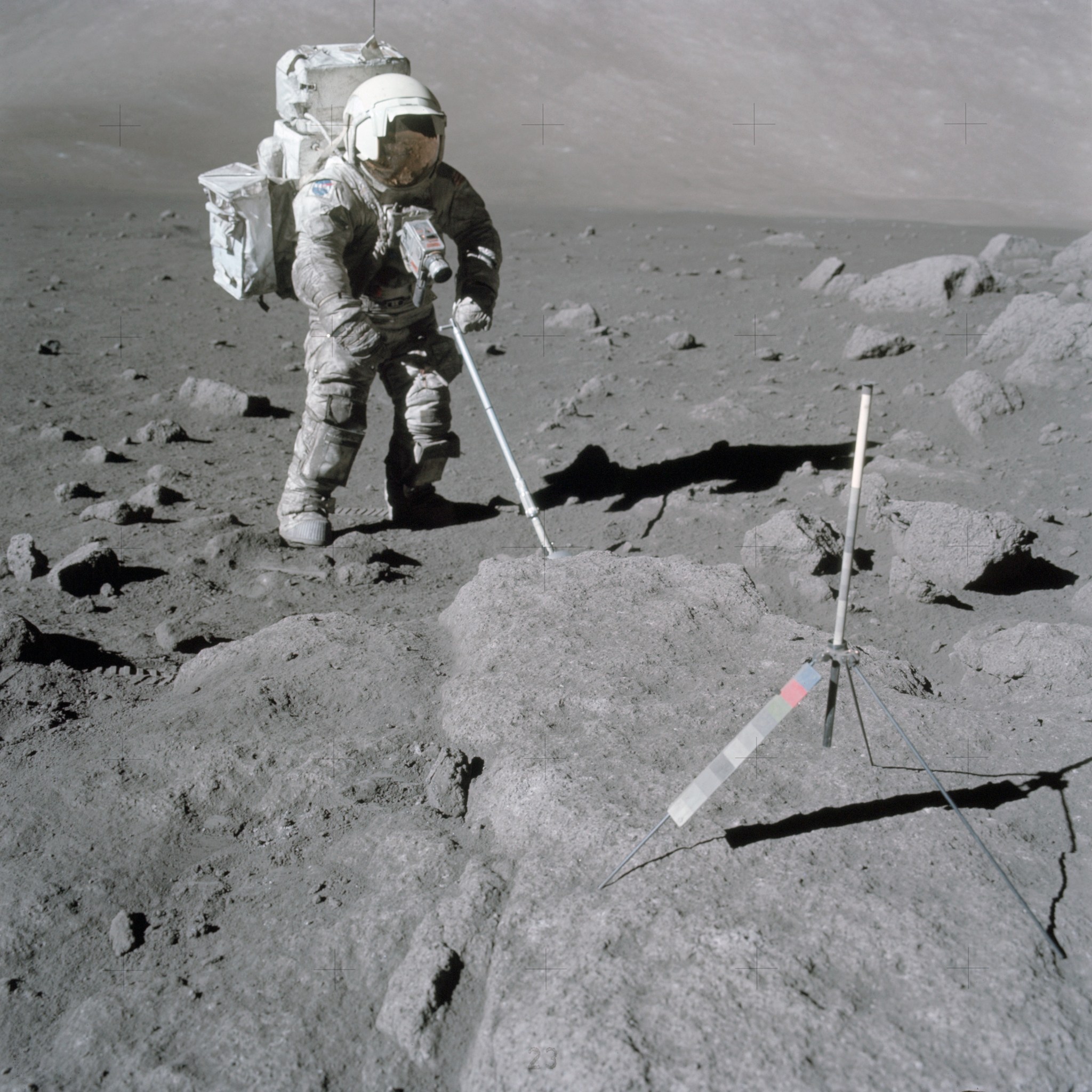 Astronaut on lunar surface taking samples.