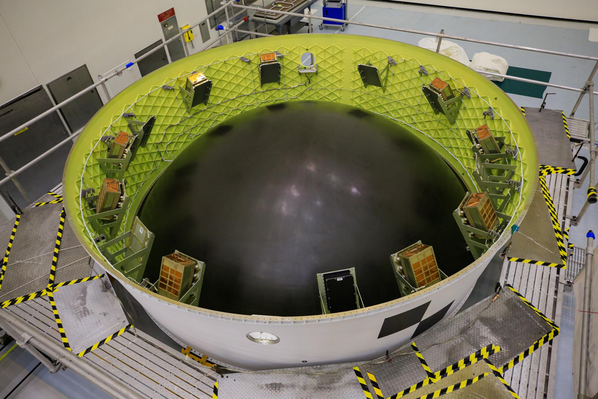 View of the shoebox-sized secondary payloads as they underwent final processing and were secured inside the Orion stage adapter.