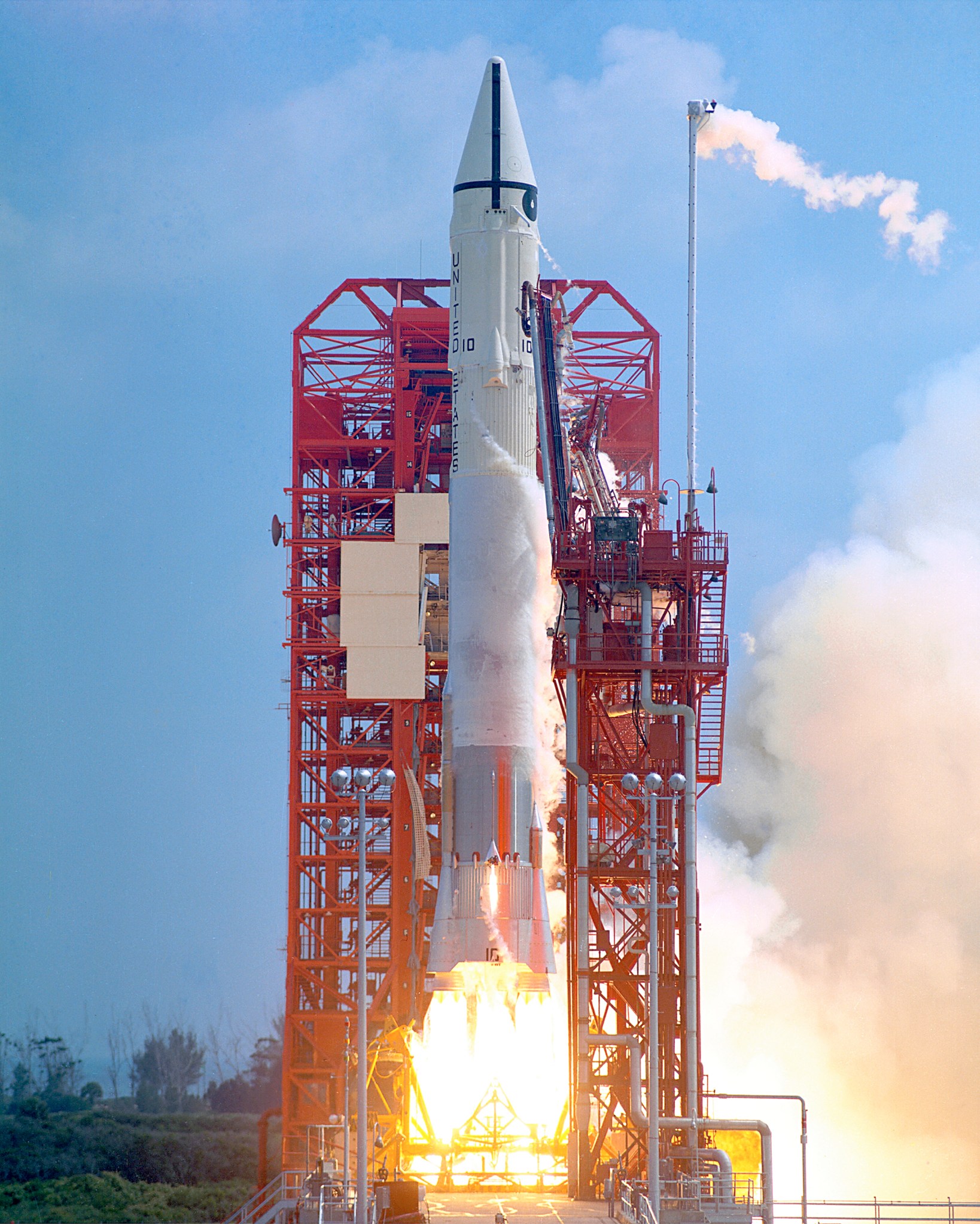 Rocket lifting off from launch tower.