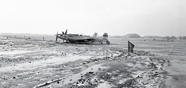 Aircraft that slid off runway with front wheels sunk in mud.