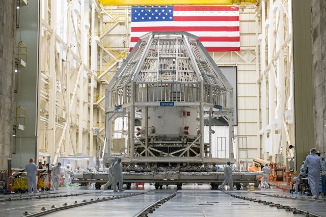 Orion spacecraft in vacuum chamber with scaffolding around it.