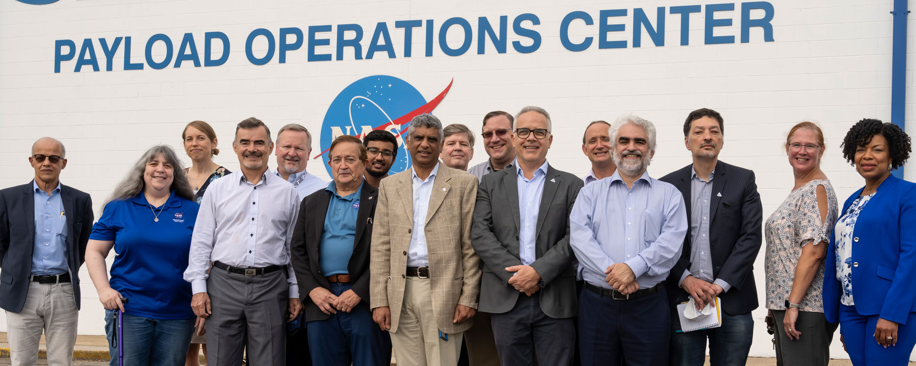 Senior officials from the Brazilian Space Agency, the Brazilian Ministry for Science, Technology, and Innovation, and a professor from Brazil’s Technological Institute of Aeronautics pose for a photograph with NASA team members
