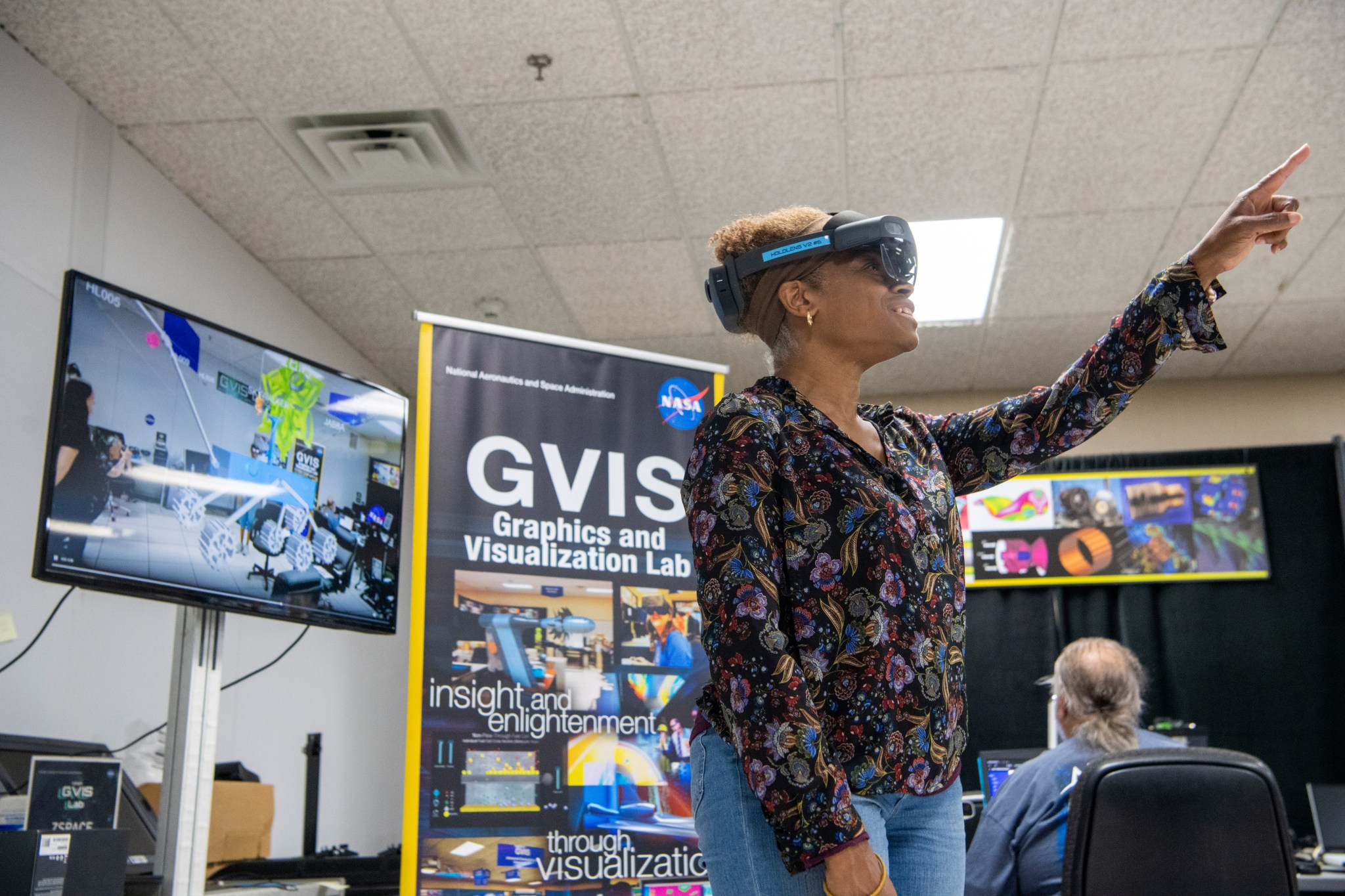 A NASA Engineer collaborates with Shasta High School students during the final presentations of the student’s mission concepts at the Graphics and Visualization Lab at NASA’s Glenn Research Center.