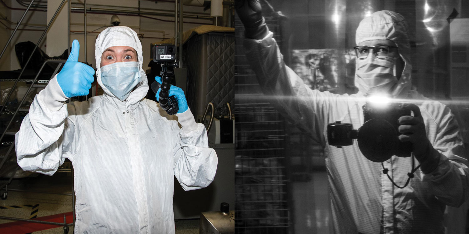 Two pictures side by side. Desiree Stover, a lead documentary photographer on NASA's PACE mission, wearing a white clean room u0022bunny suitu0022 with a white hood over her hair and a white mask over the lower half of her face. She is smiling and holding a black camera in her gloved hand and giving a thumbs up with the other.  Black and white photo of Denny Henry, PACE’s lead mission photographer, taking a picture in a mirror, with a big black camera. He is wearing a white clean room suit u0022bunny suit,u0022 including a white hood over his hair and blue gloves.