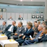 A group of men listen to a presentation at the blockhouse of Launch Complex 34 at the Cape Canaveral Missile Test Annex in Florida. Seated, from the left, are NASA Administrator James E. Webb, Vice President Lyndon B. Johnson, Launch Operations Center Director Kurt H. Debus and President John F. Kennedy.