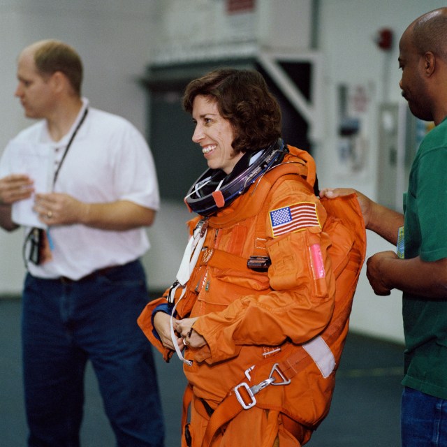 STS-110 Water Survival Training in the Neutral Buoyancy Laboratory (NBL). View of astronaut Ellen Ochoa, Flight Engineer (FE) dons a Launch and Entry Suit (LES).