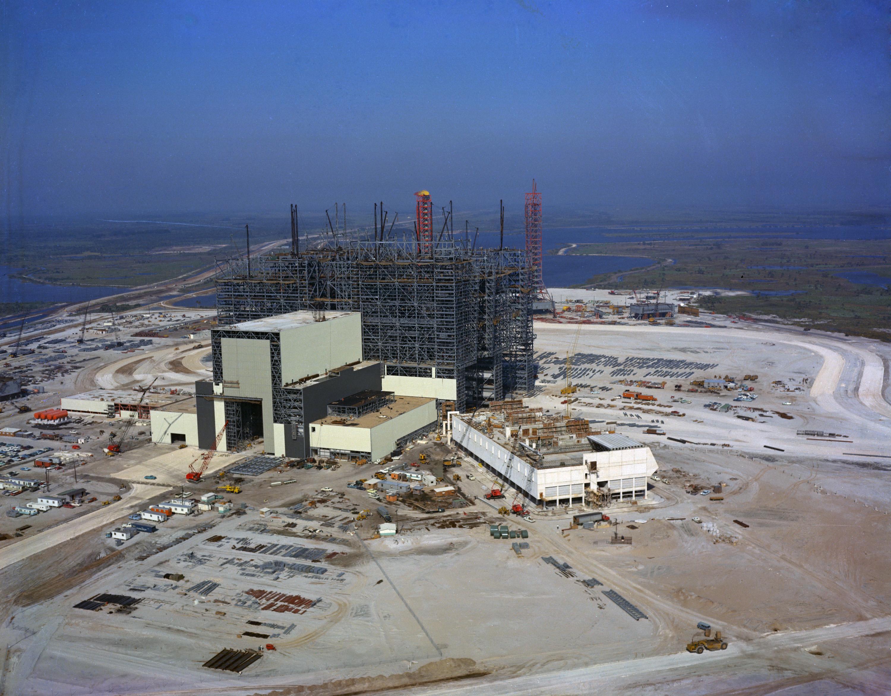 Aerial view of the Vehicle Assembly Building site at Kennedy Space Center showing the building under construction.