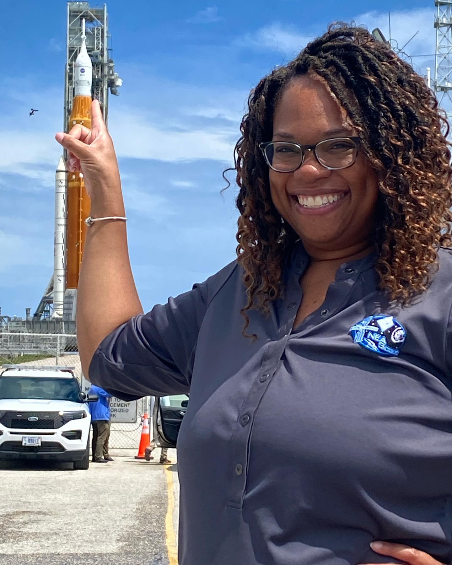 Tiffany Lockett standing with SLS Rocket.