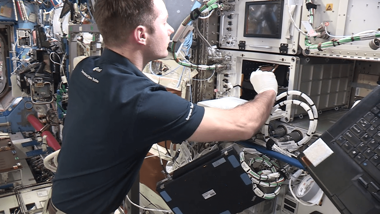 image of an astronaut working with an experiment