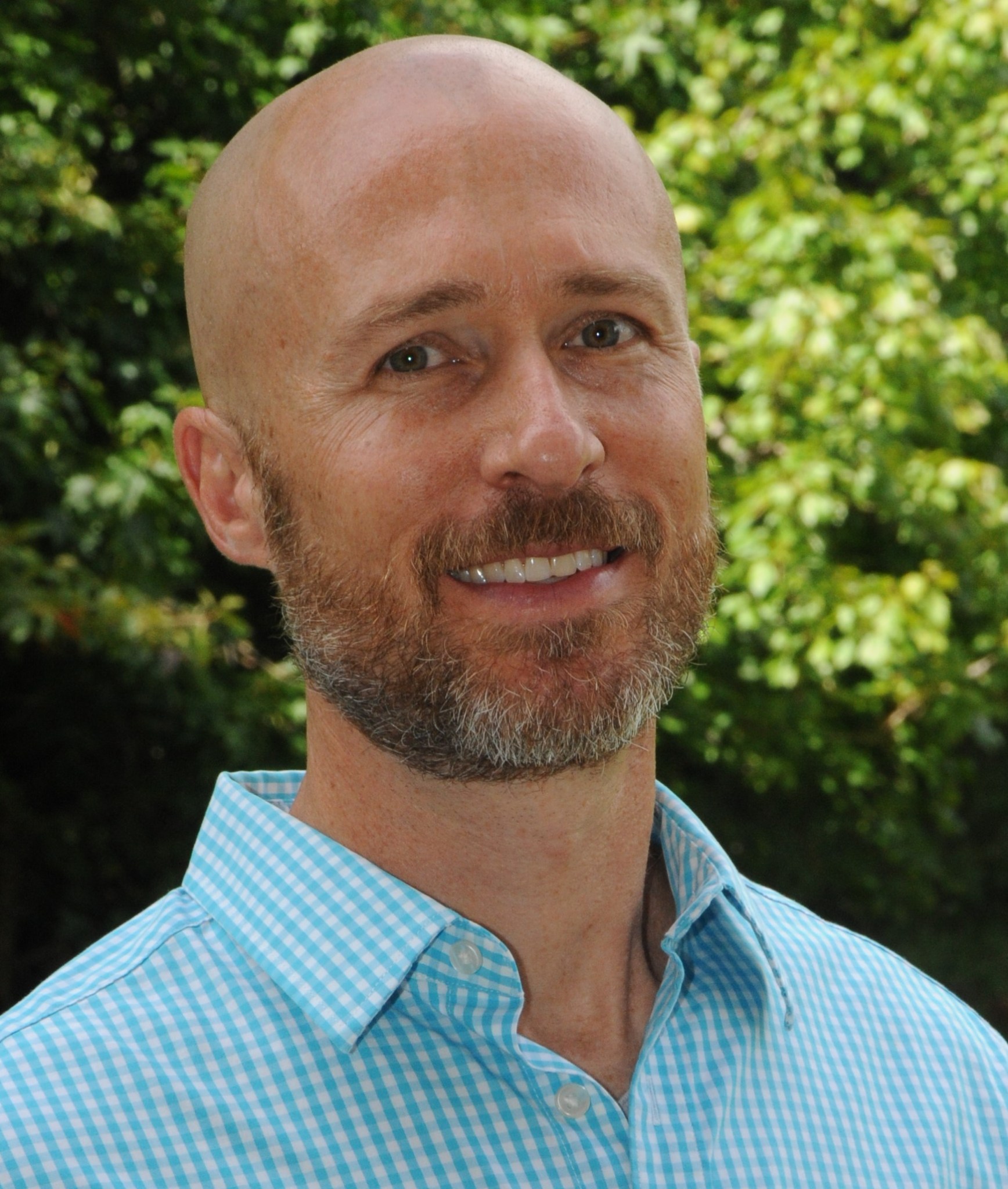 Matthew Rodell portrait with green trees as backdrop