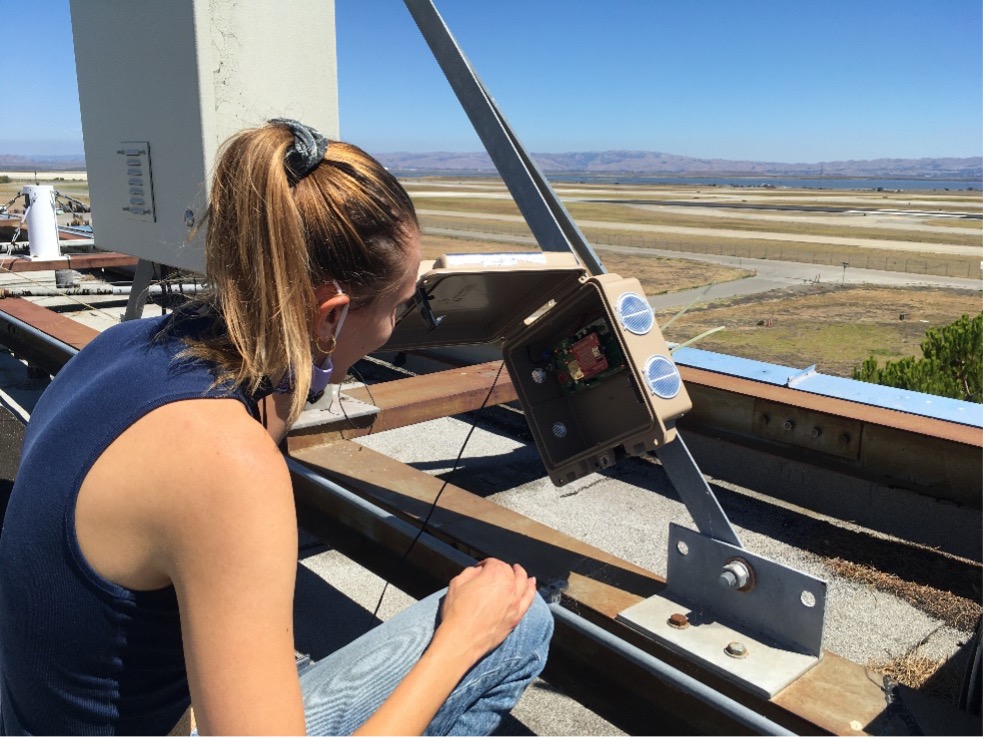 Okorn installing an INSTEP monitor on a rooftop at NASA Ames
