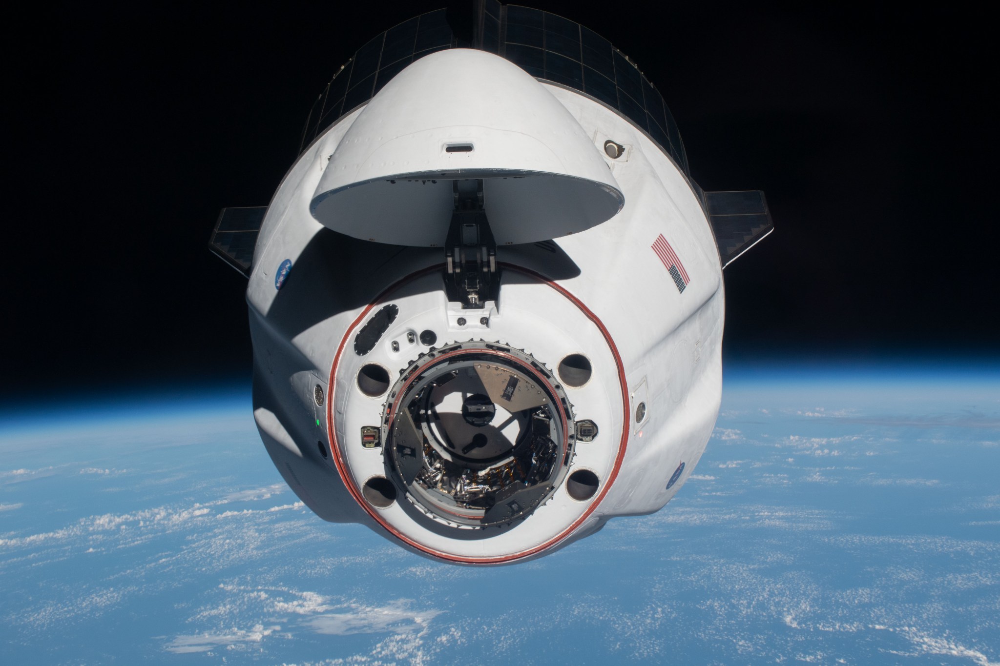 image of SpaceX Dragon with limb of Earth in background
