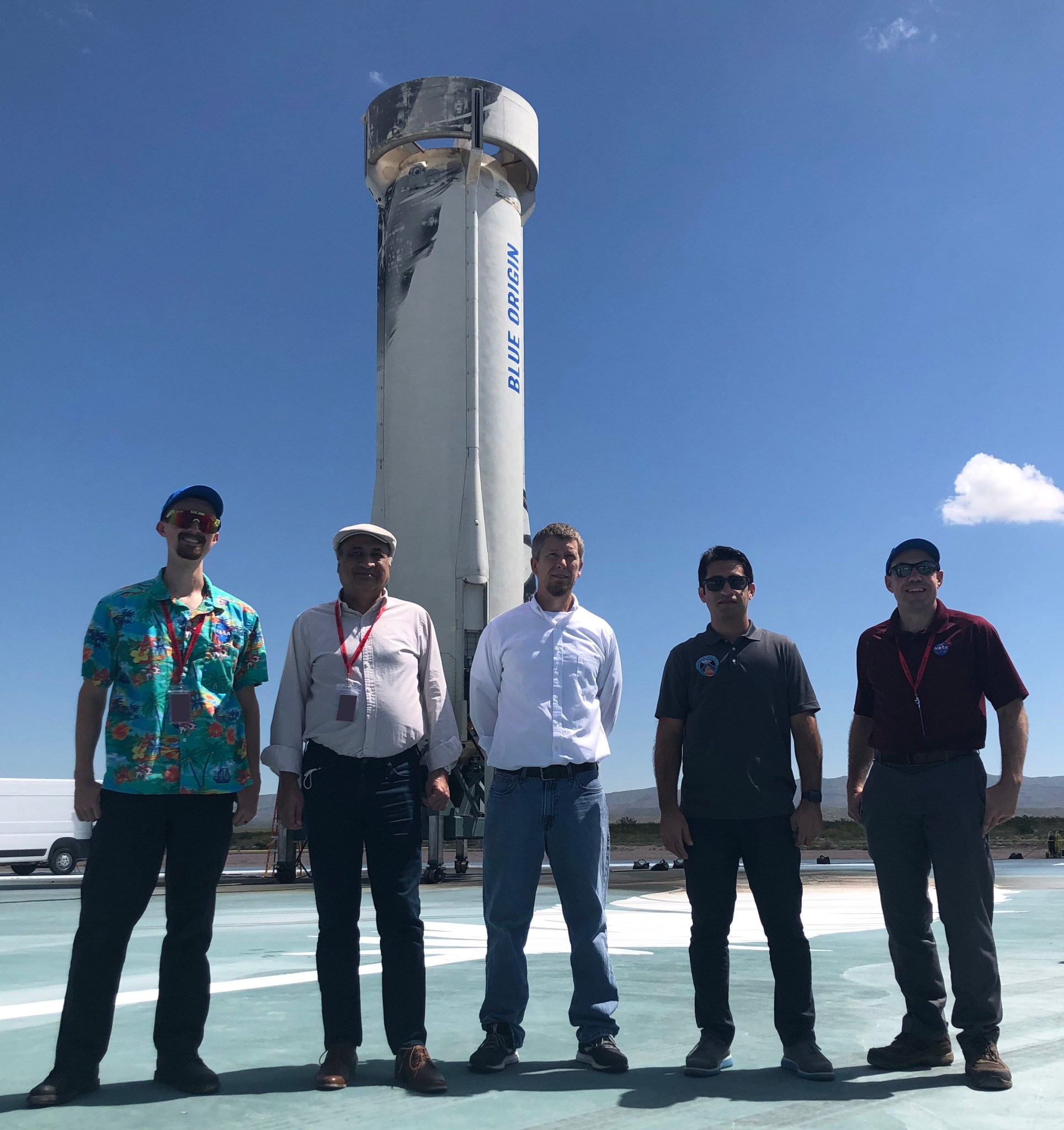 Team in front of a rocket booster.