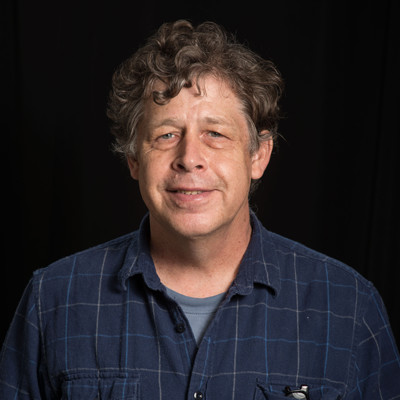 Michael Zolensky, photographed against a black background.