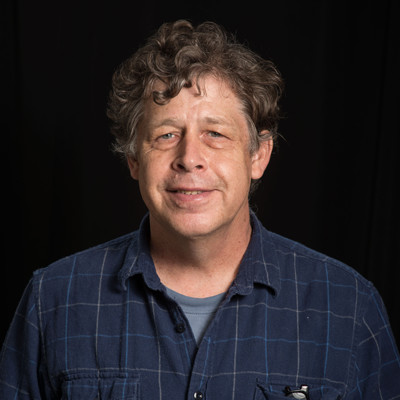 Michael Zolensky, photographed against a black background.