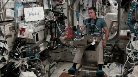 moving image of an astronaut manipulating objects as part of an investigation