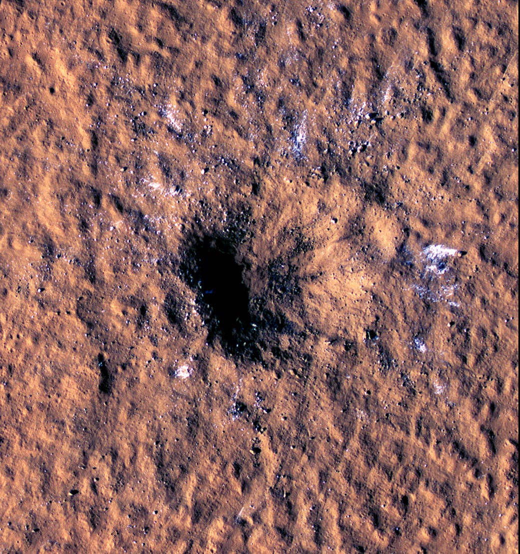 Boulder-size blocks of water ice can be seen around the rim of an impact crater on Mars