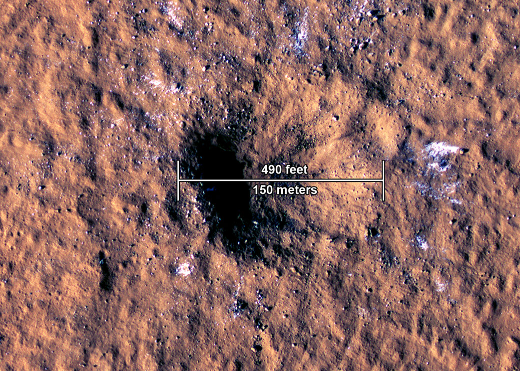 The impact crater, formed Dec. 24, 2021, by a meteoroid strike in the Amazonis Planitia region of Mars