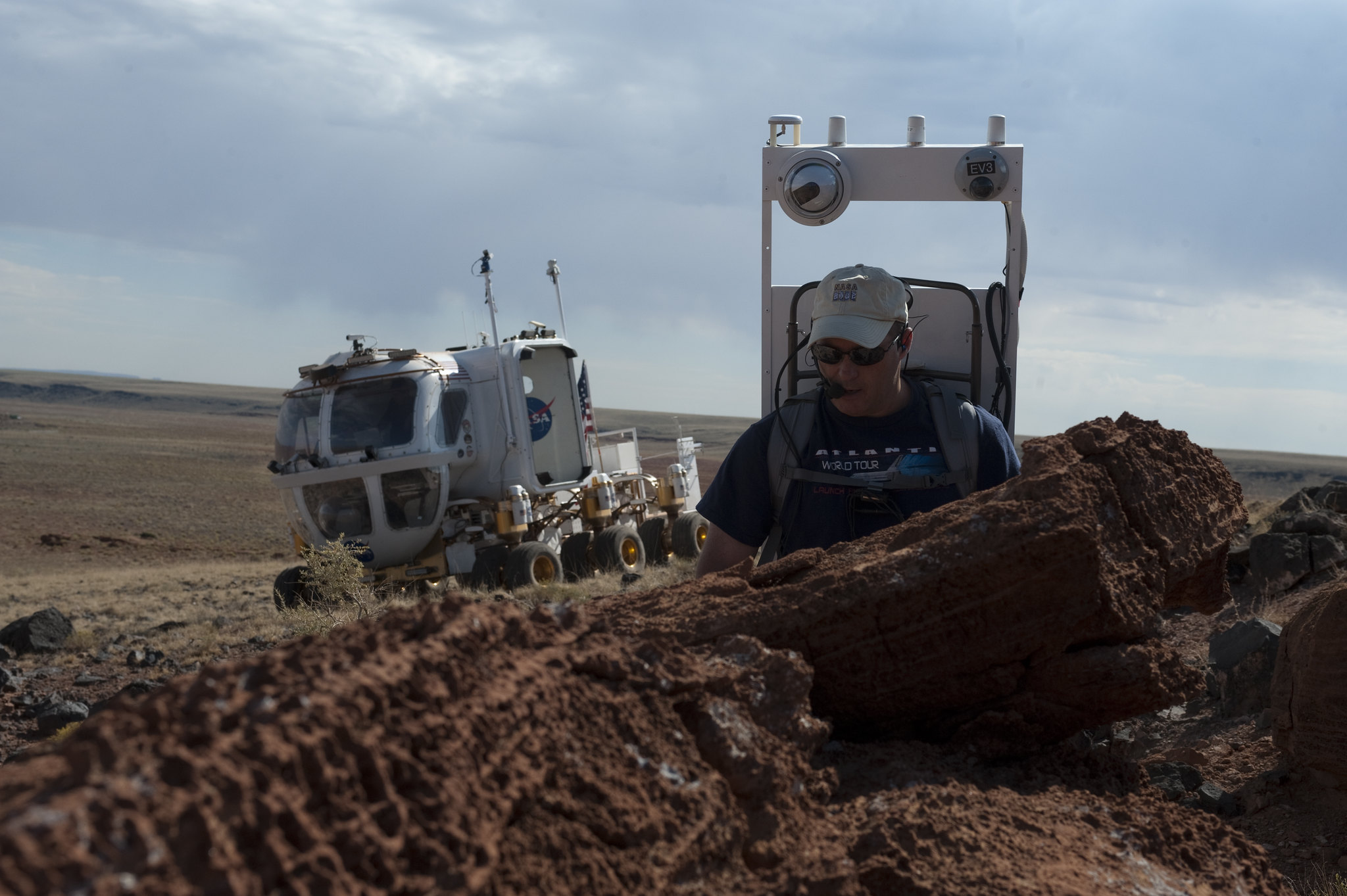 Astronaut Scott Tingle takes a closer look at rock formations at Black Point Lava Flow, Arizona  during a simulated spacewalk on day 5 of NASA’s Desert Research and Technology Studies (D-RATS) in 2011.