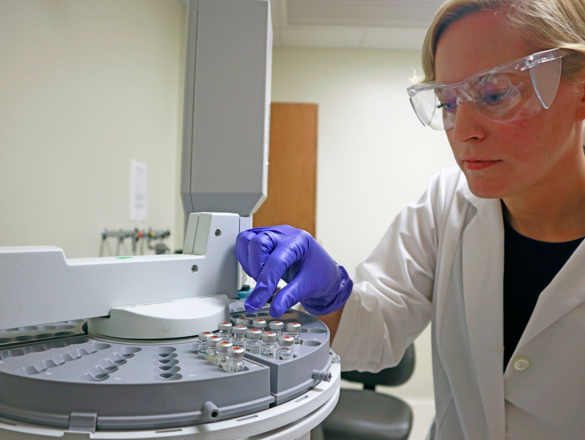 NASA scientist Janice Zawaski handles samples in a mass spectrometer that researchers use to study how cells react to different environments.