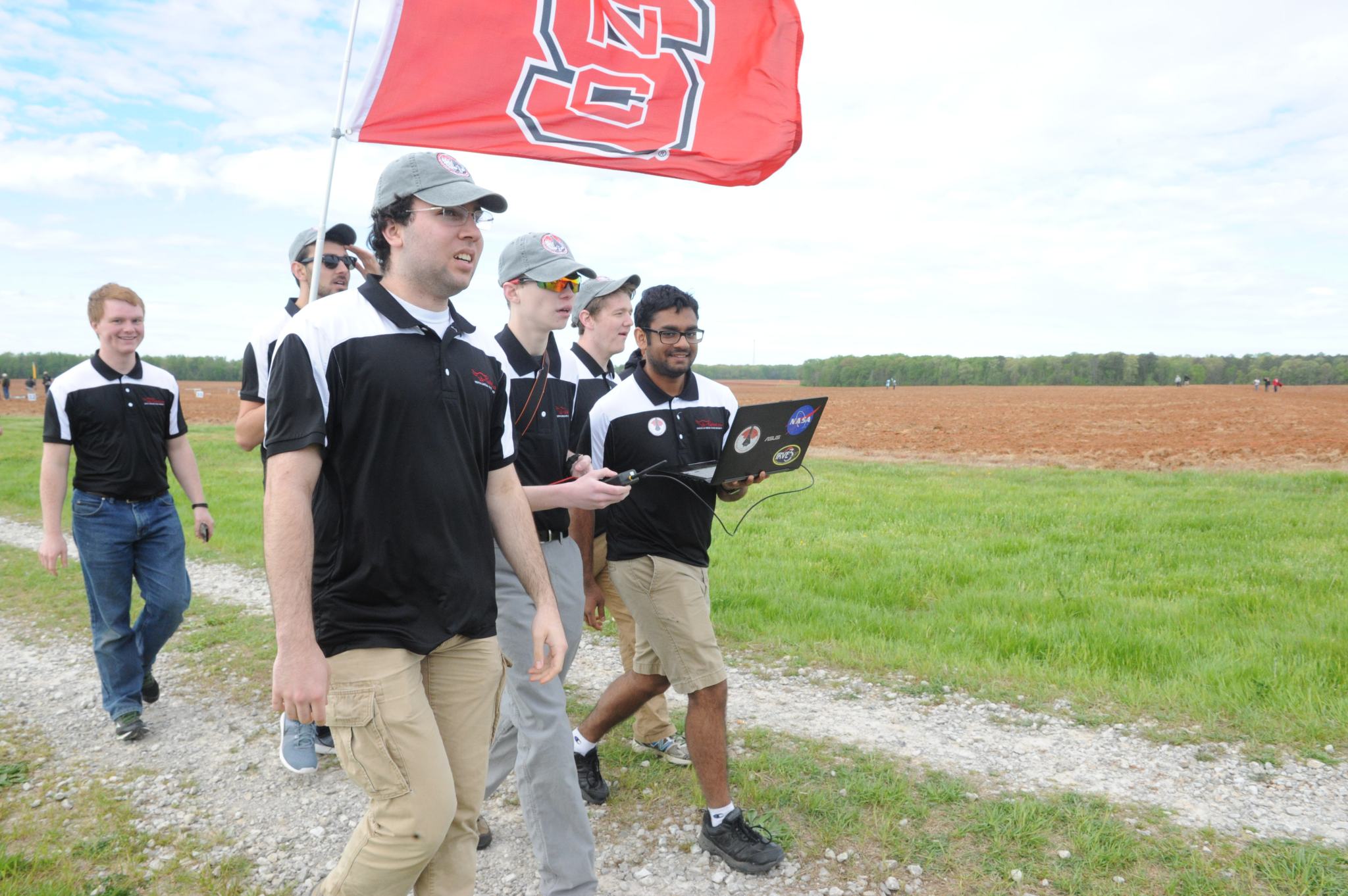 John Inness, front left, leads the North Carolina State University team to the launch pad during NASA’s 2016 Student Launch Challenge. 