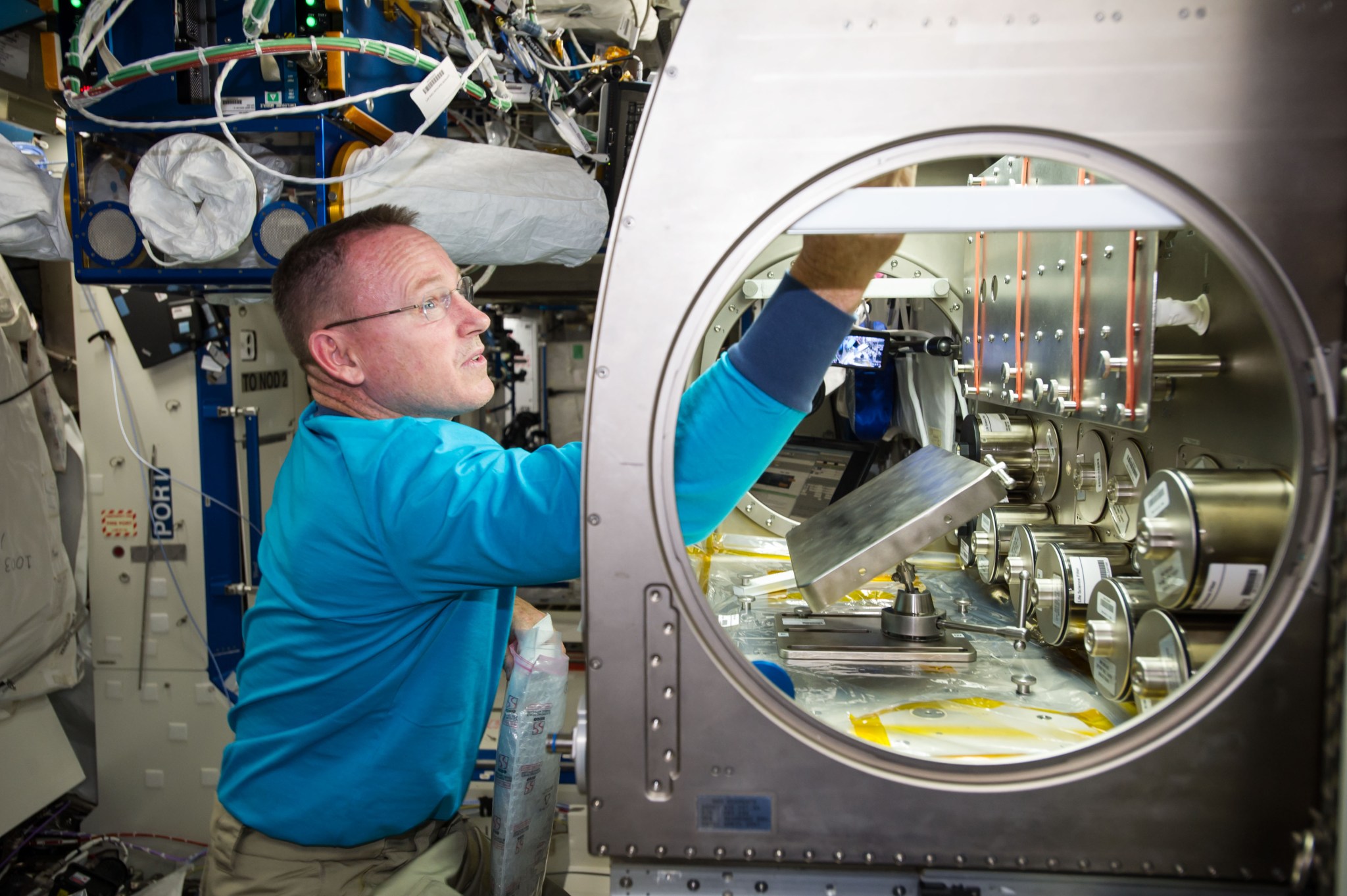 NASA astronaut Barry "Butch" Wilmore setting up the Rodent Reseach-1 Hardware in the Microgravity Science Glovebox aboard the International Space Station
