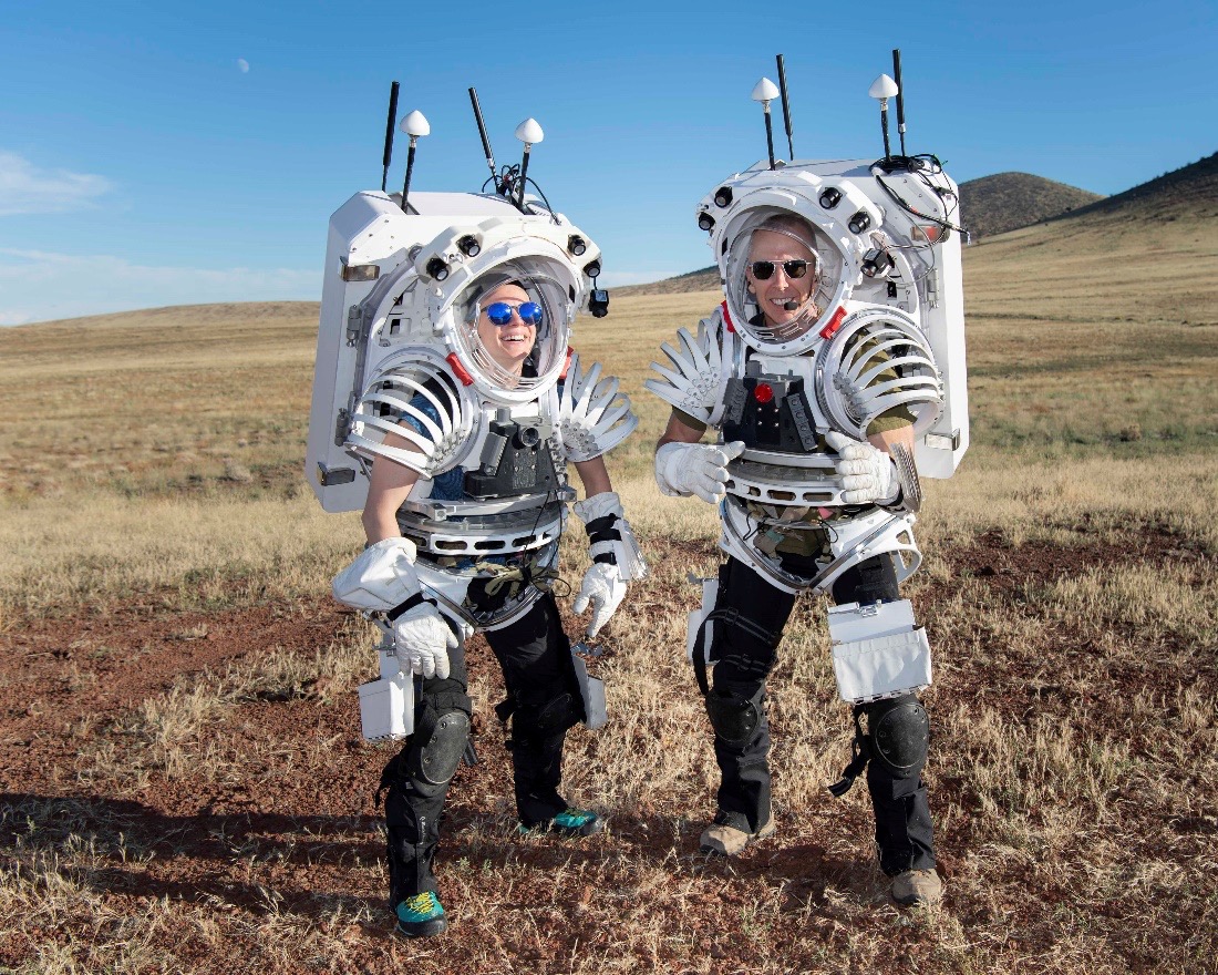 Photo of NASA astronauts Zena Cardman and Drew Feustel wearing mockup spacesuits after performing an engineering test run before a week of simulated moonwalks.