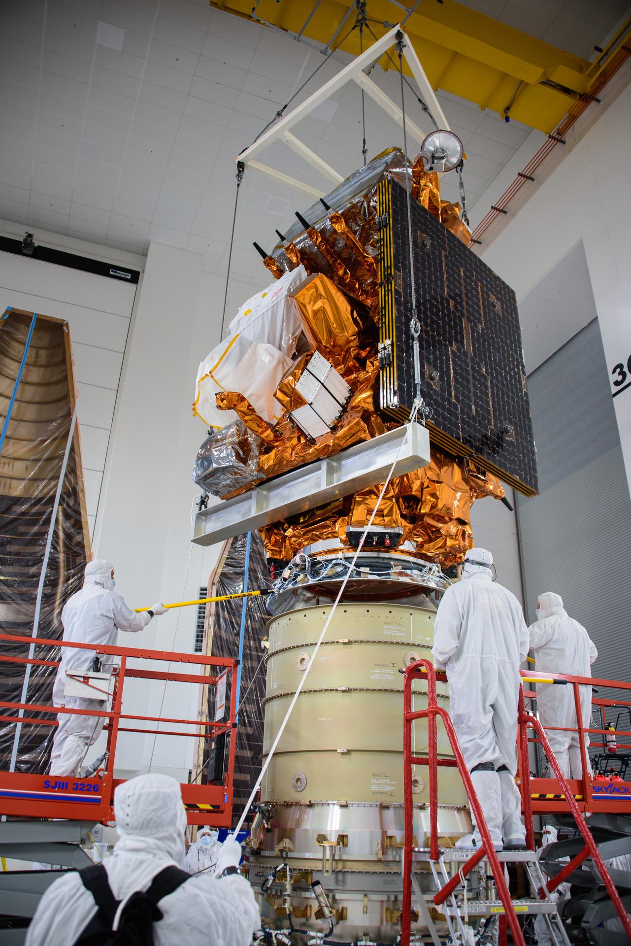 Technicians lower NOAA's JPSS-2 satellite onto the LOFTID payload inside the Astrotech Space Operations Facility at Vandenberg Space Force Base in California.