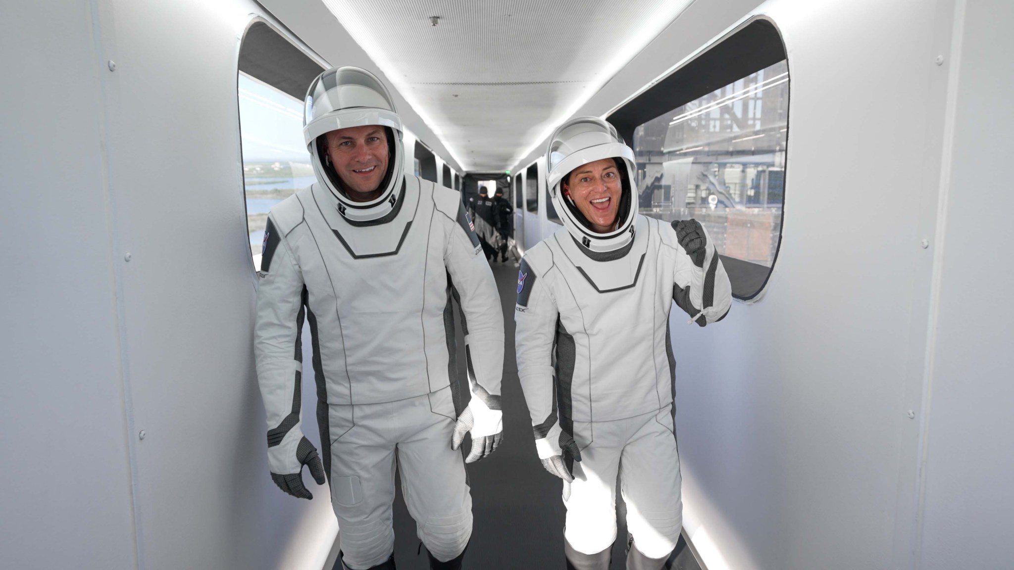 SpaceX Crew-5 Pilot Josh Cassada, left, and Commander Nicole Mann, both NASA astronauts, are pictured walking on the crew access arm toward the Dragon Endurance crew ship atop the Falcon 9 rocket at Launch Pad 39A of Kennedy Space Center in Florida.