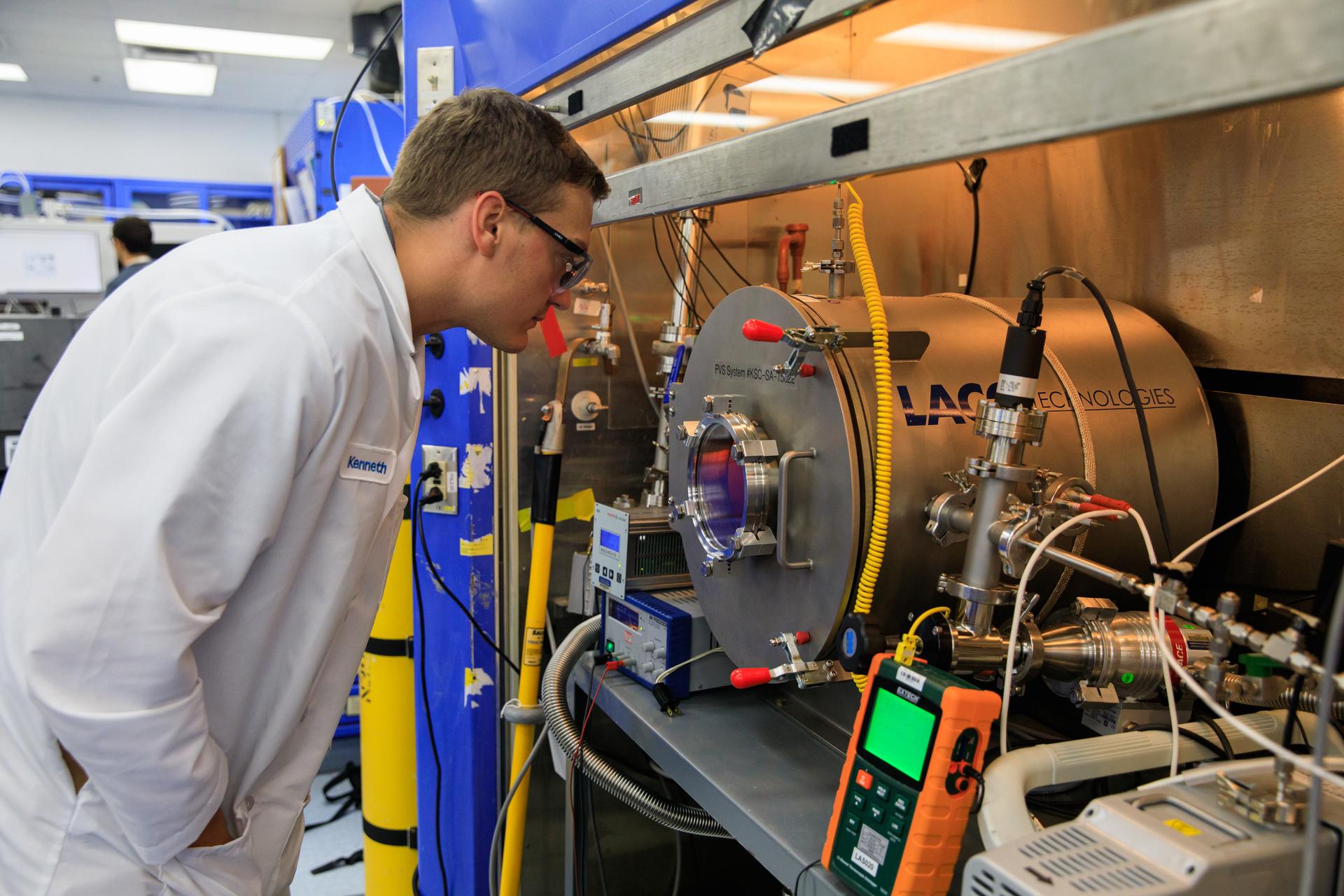 Kenneth Engeling conducts testing of the Molten Regolith Electrolysis (MRE) inside a laboratory in the Neil A. Armstrong Operations and Checkout Building at NASA’s Kennedy Space Center in Florida on Aug. 30, 2022. 
