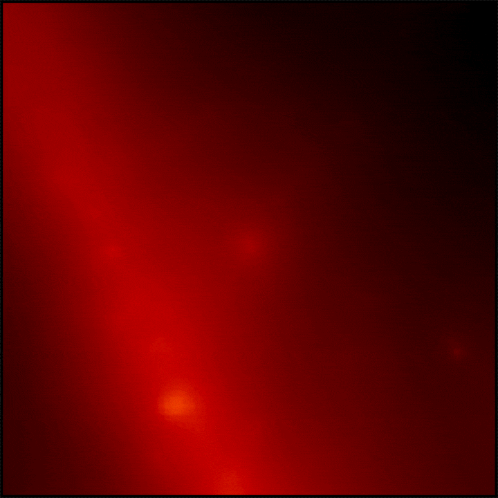 A white, gold, and red burst representing gamma rays from GRB 221009A appears and fades near a reddish diagonal band, the gamma-ray glow of the Milky Way 