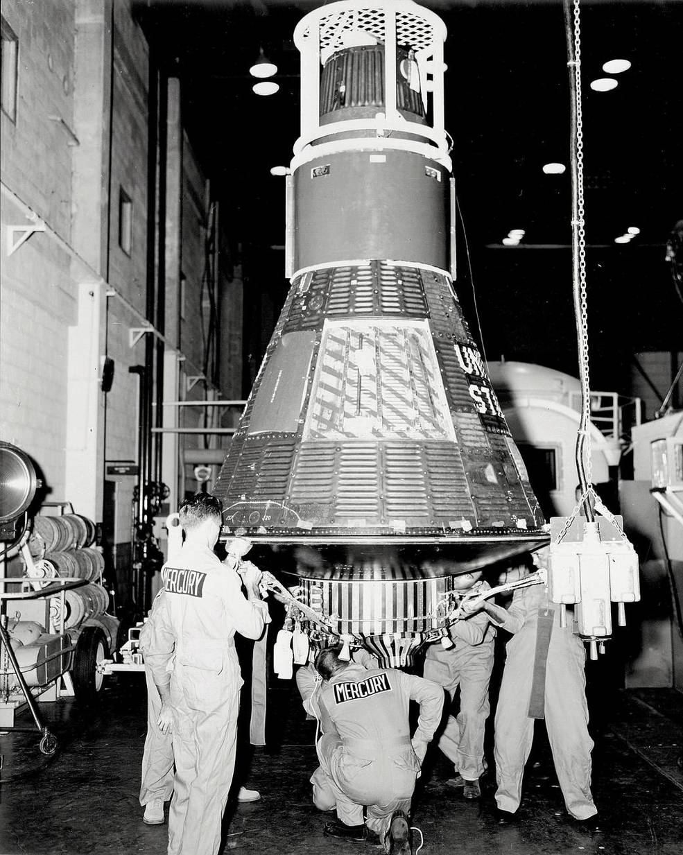 In September 1963, engineers and technicians in Hangar S, prepare the Mercury 8 capsule named "Sigma 7."