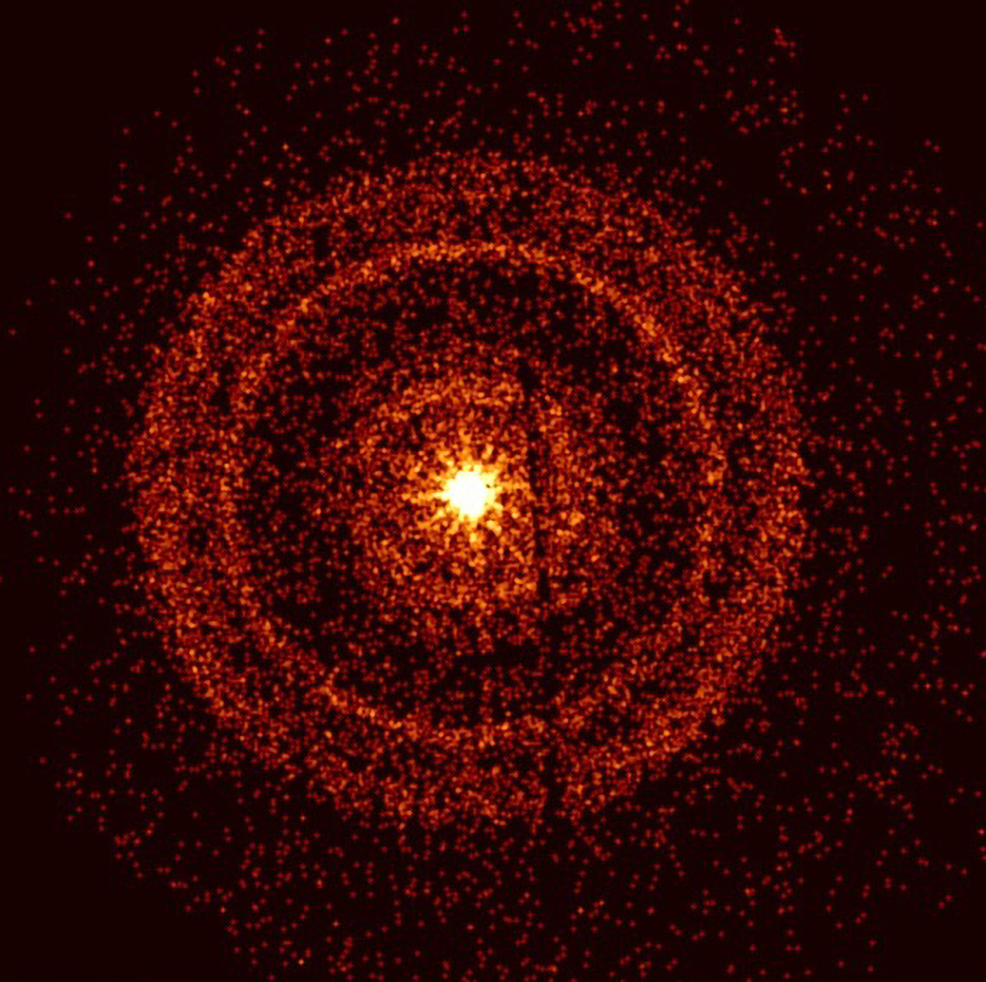 Concentric reddish rings of varying width surround a bright yellow star-like source in this X-ray image of GRB 221009A from NASA's Swift.  