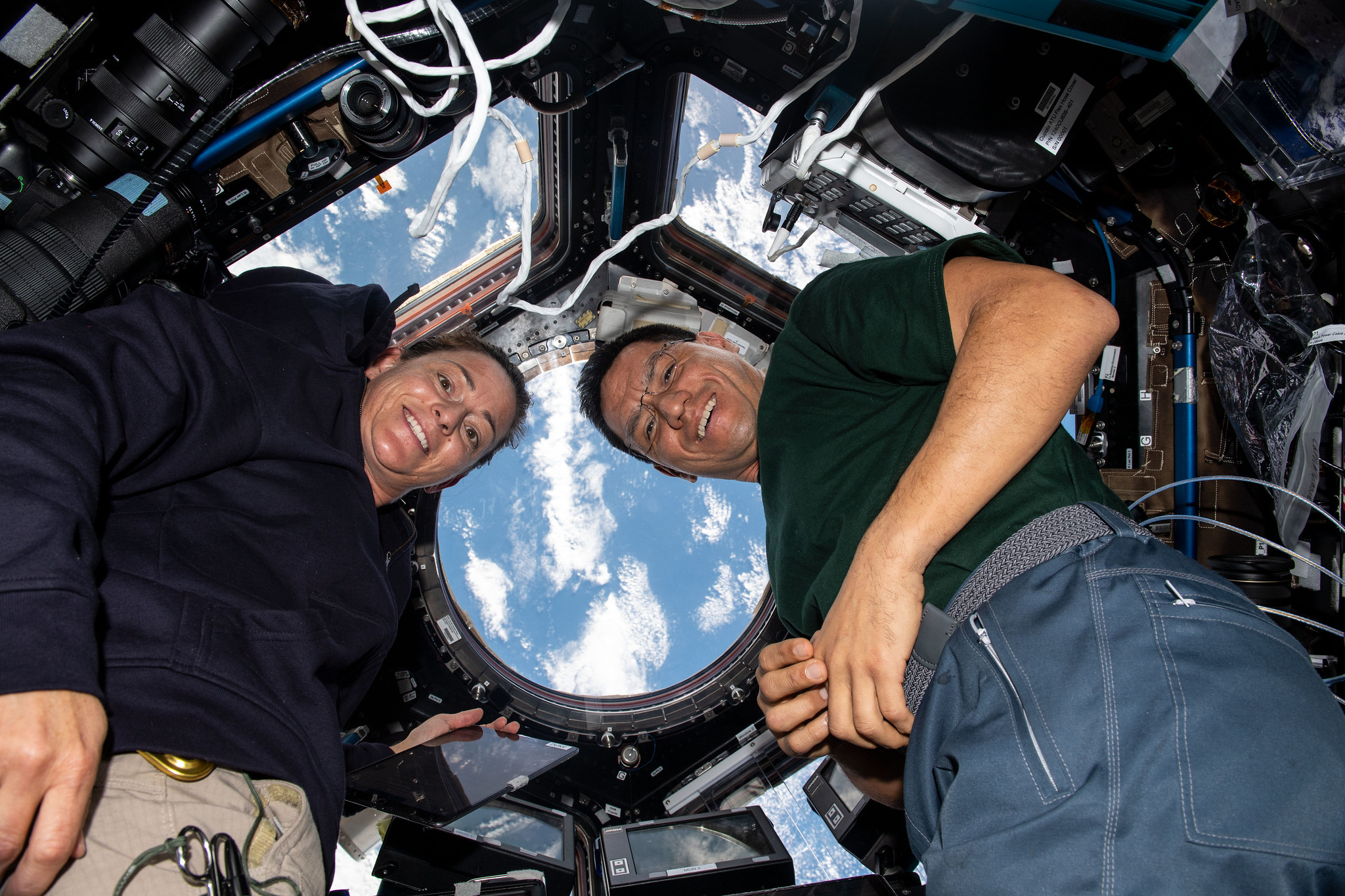 NASA astronauts Nicole Mann and Frank Rubio are seen inside the cupola with the south Atlantic Ocean visible through its windows as the International Space Station orbits 272 miles above Earth. 