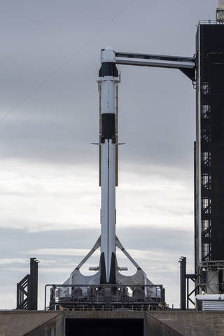 A SpaceX Falcon 9 rocket, with the company’s Dragon cargo spacecraft atop, is raised to a vertical position at NASA Kennedy Space Center on Nov. 21, 2022, in preparation for the 26th commercial resupply services launch to the International Space Station.