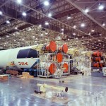 The photograph shows Saturn V S-IC flight stages being assembled in the horizontal assembly area at the MAF.