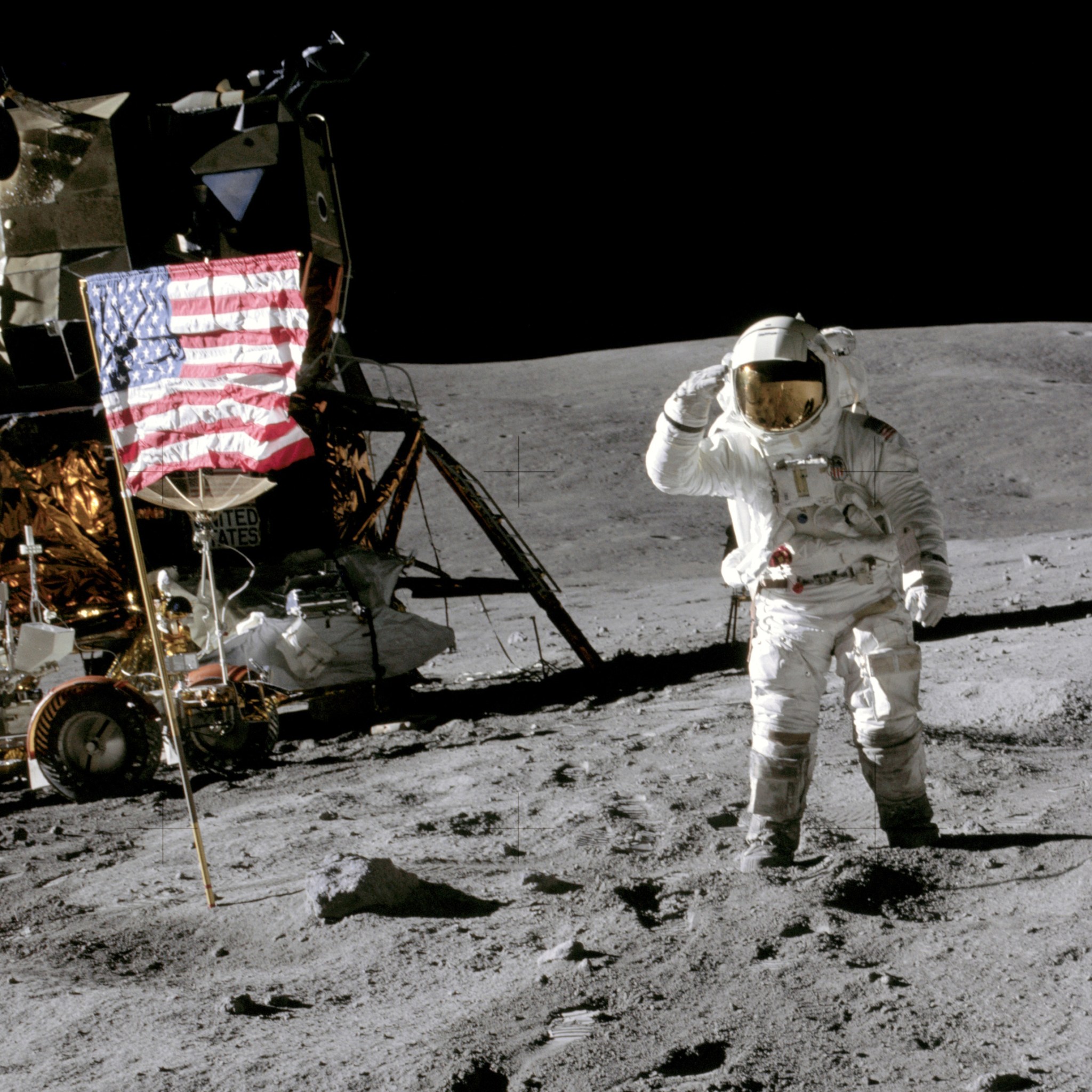Apollo 16 Lunar Module Pilot Charles Duke salutes the flag