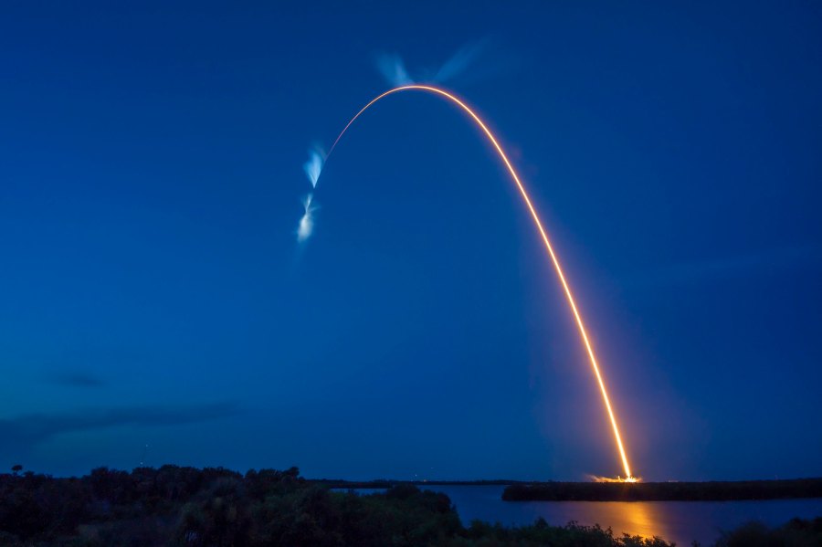 A bright white trail is in view after the SpaceX Falcon 9 rocket carrying the Dragon capsule lifts off from Launch Complex 39A at NASA’s Kennedy Space Center in Florida on July 14, 2022, on the company’s 25th Commercial Resupply Services mission for the agency to the International Space Station.
